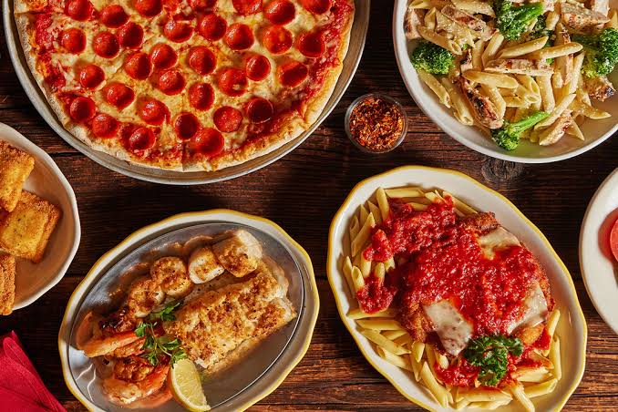 A spread of freshly cooked pasta, seafood and pizza dishes